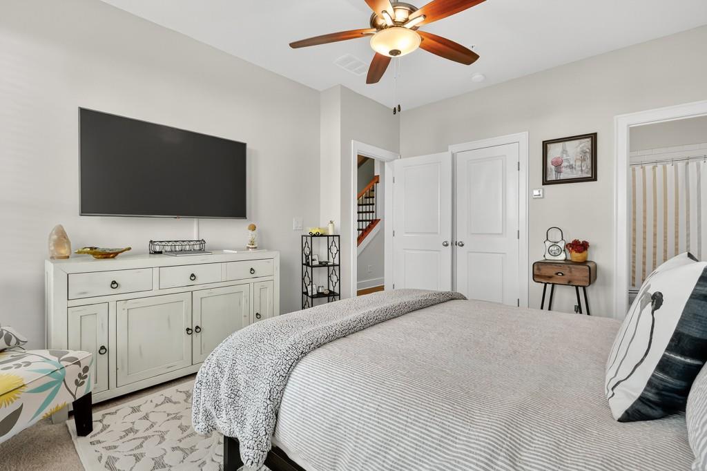 304 Liberty Way Woodstock, GA 30188 - Photo 6 of 42 a bedroom with a bed and a flat screen tv
