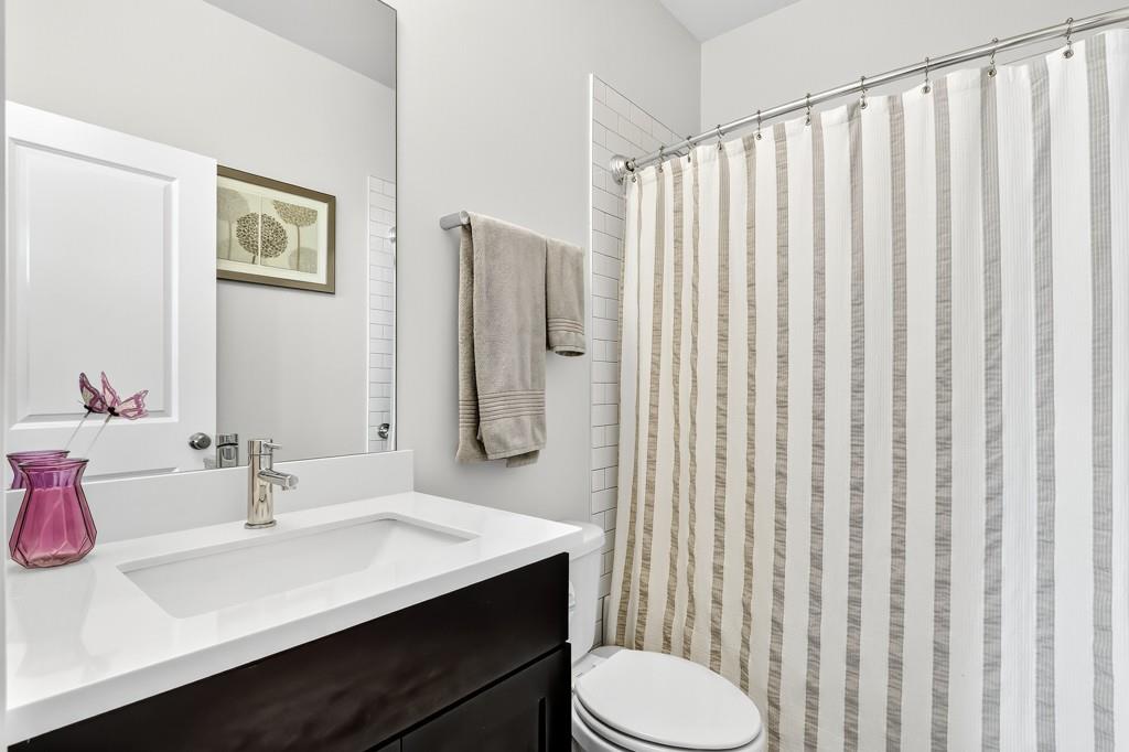 304 Liberty Way Woodstock, GA 30188 - Photo 7 of 42 a bathroom with a sink vanity mirror and toilet