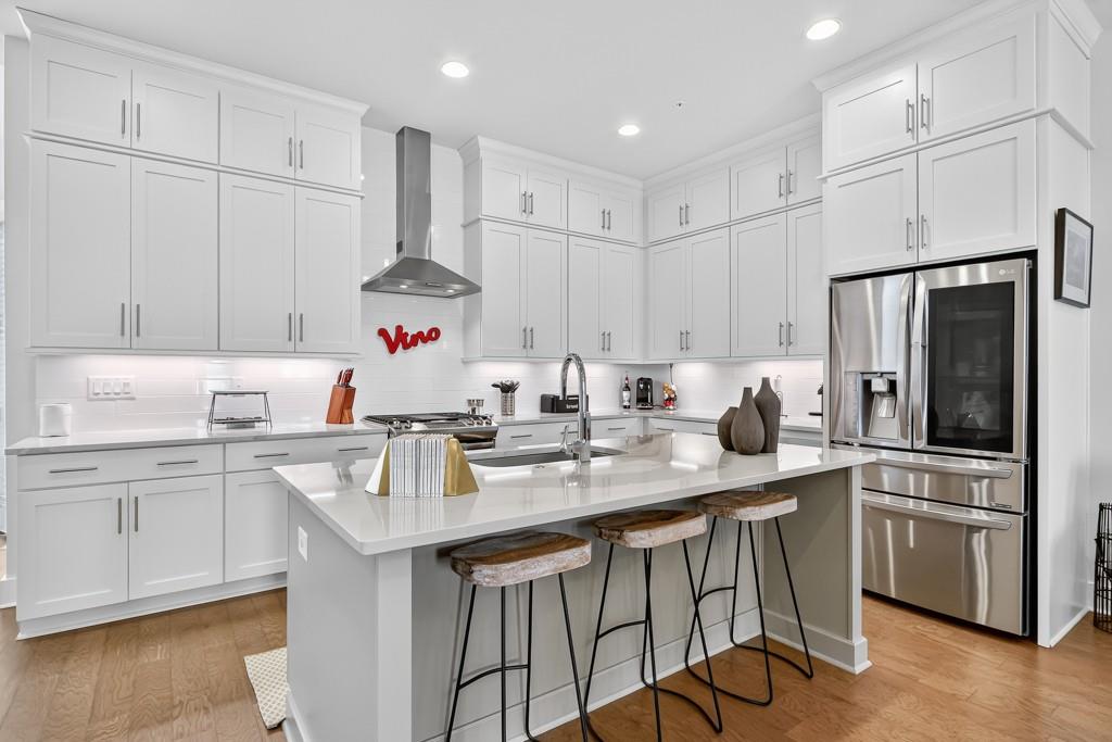 304 Liberty Way Woodstock, GA 30188 - Photo 8 of 42 a kitchen with stainless steel appliances granite countertop a sink stove and refrigerator