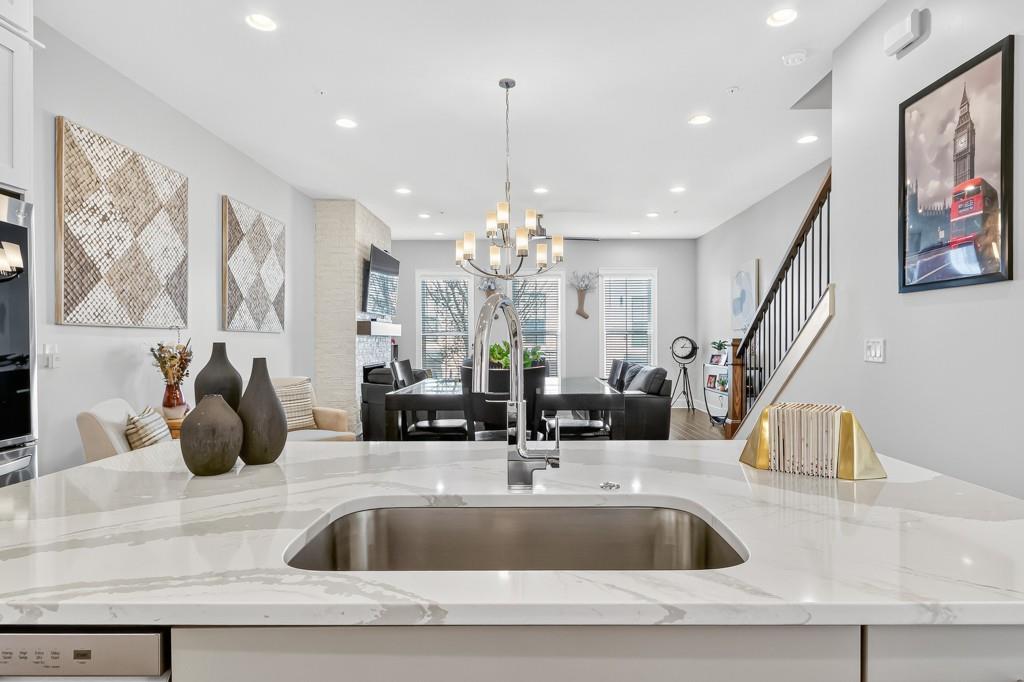 304 Liberty Way Woodstock, GA 30188 - Photo 9 of 42 a kitchen with a sink and chandelier