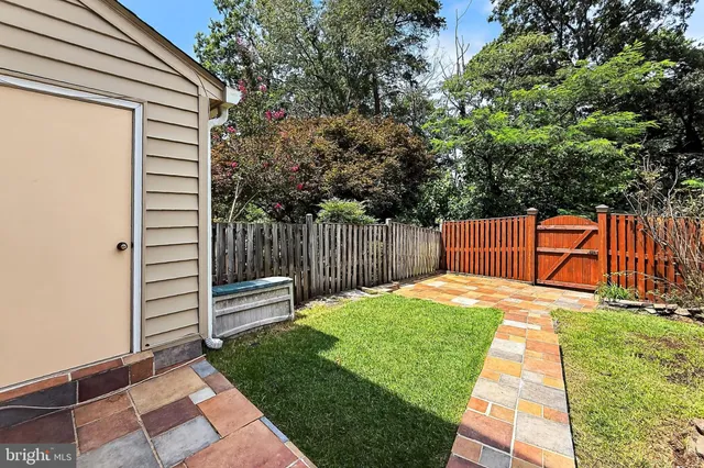 a backyard of a house with table and chairs