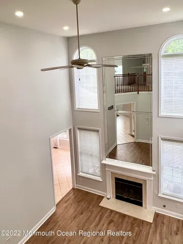 a kitchen with stainless steel appliances granite countertop a refrigerator a sink a stove and a wooden floors