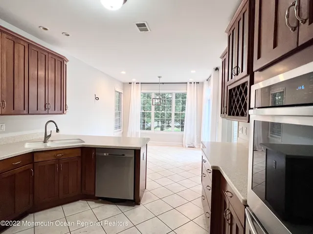 a kitchen with a sink stove and cabinets