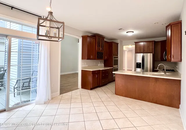 a kitchen with stainless steel appliances a sink and a refrigerator