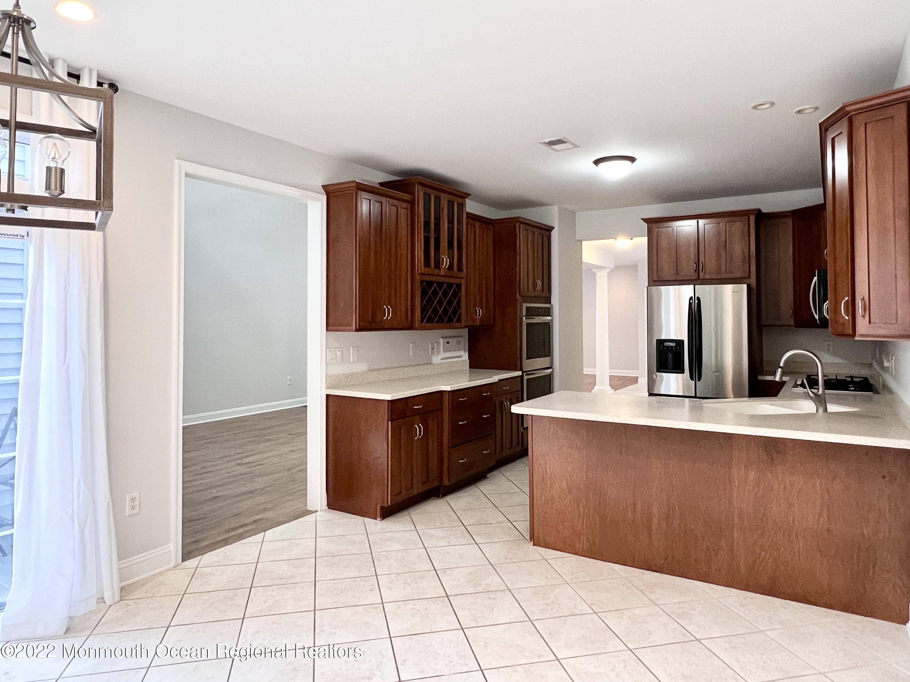 1 Hendrickson Court Manalapan, NJ 07726 - Photo 17 of 39 a large kitchen with stainless steel appliances a sink and cabinets
