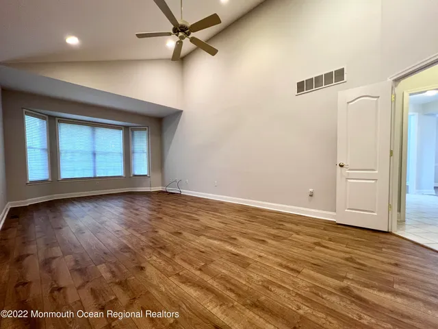 a spacious bathroom with a tub sink and mirror