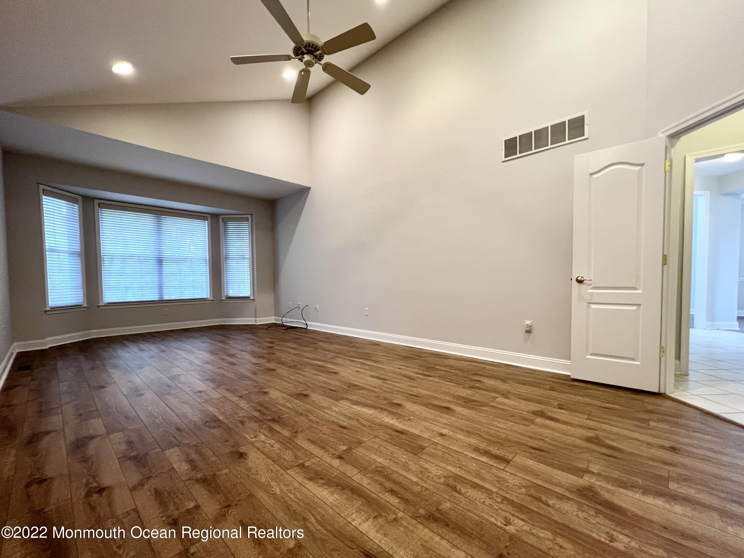 1 Hendrickson Court Manalapan, NJ 07726 - Photo 27 of 39 an empty room with wooden floor cabinet and windows