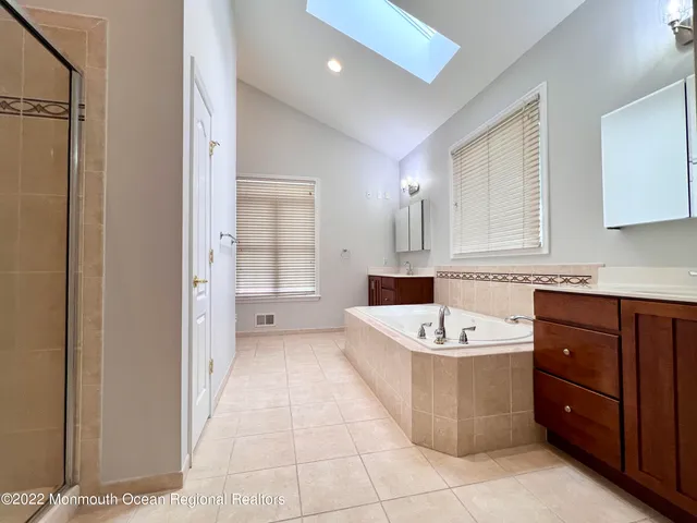 a bathroom with a tub and shower