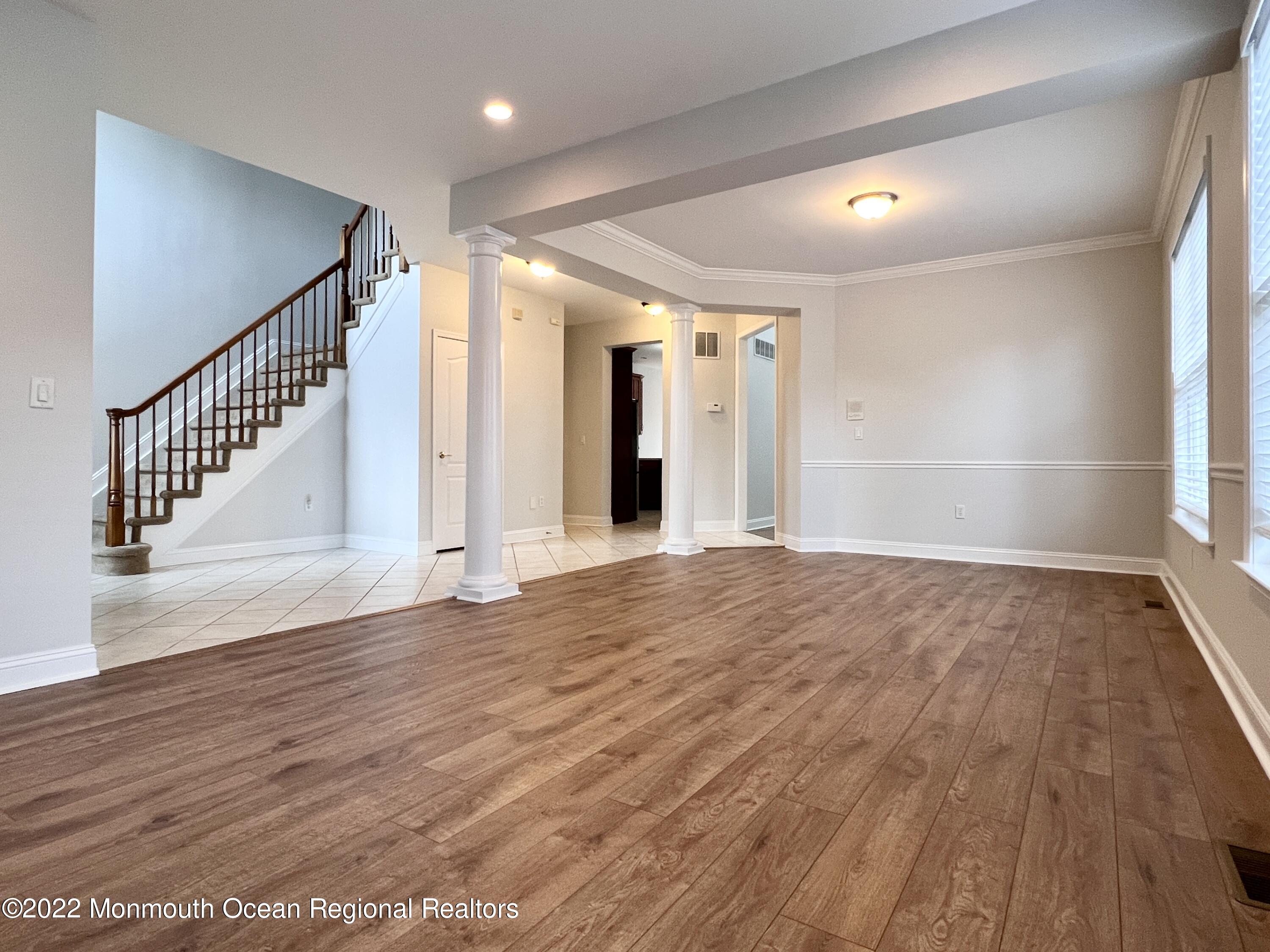 1 Hendrickson Court Manalapan, NJ 07726 - Photo 3 of 39 an empty room with wooden floor and windows