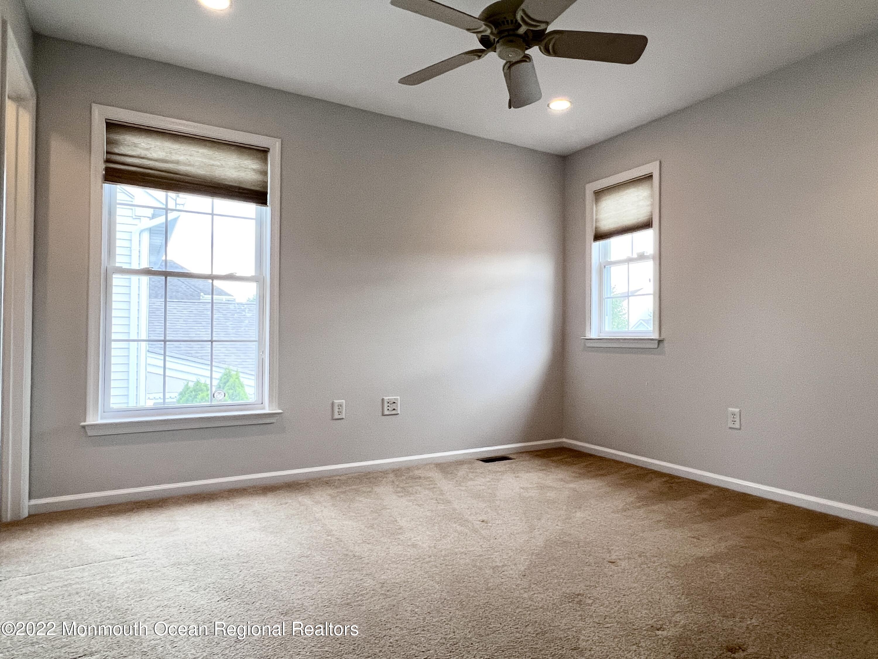 1 Hendrickson Court Manalapan, NJ 07726 - Photo 31 of 39 an empty room with a window and a fan