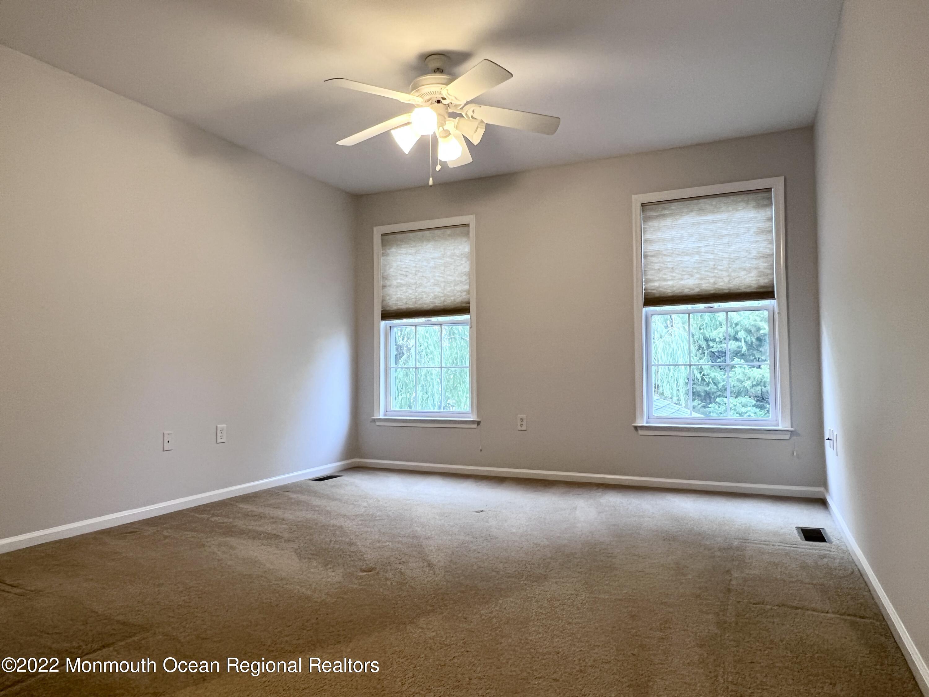 1 Hendrickson Court Manalapan, NJ 07726 - Photo 33 of 39 an empty room with windows and fan