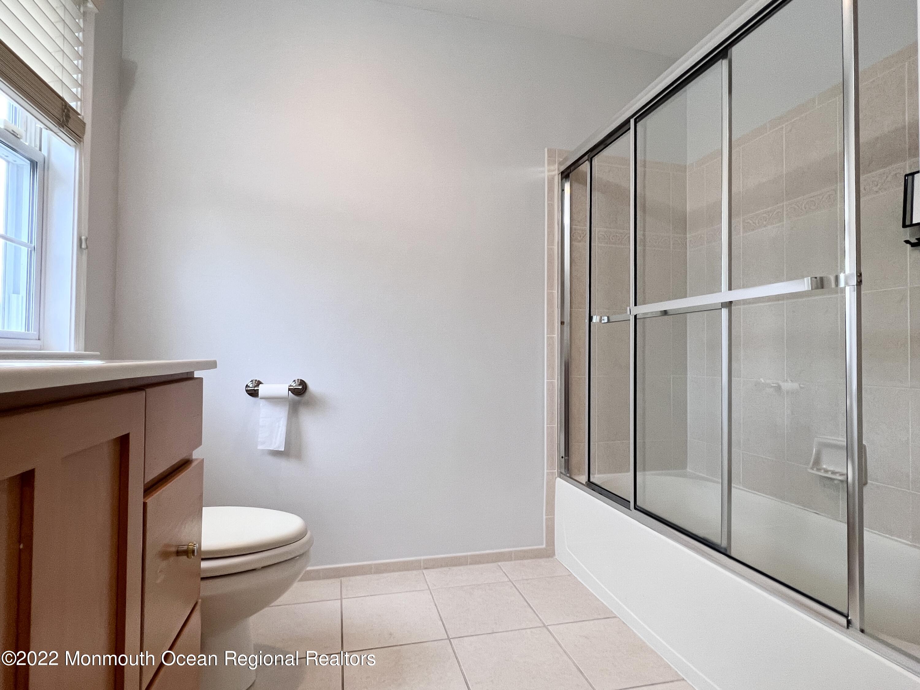 1 Hendrickson Court Manalapan, NJ 07726 - Photo 36 of 39 a bathroom with a toilet a sink and shower