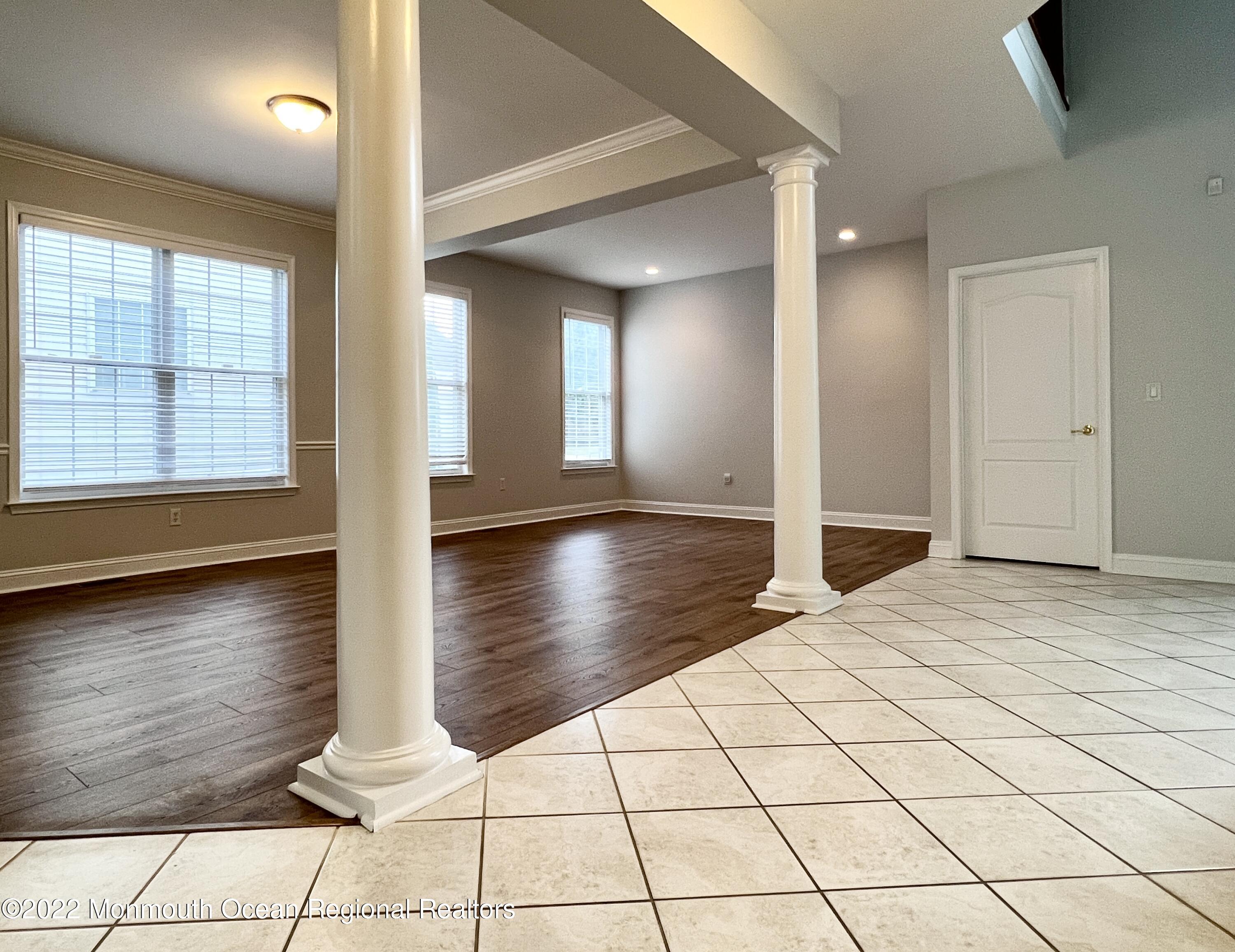 1 Hendrickson Court Manalapan, NJ 07726 - Photo 7 of 39 a view of empty room with wooden floor and fan