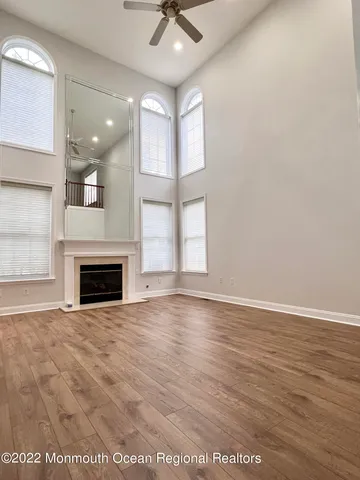 an empty room with windows and a fireplace