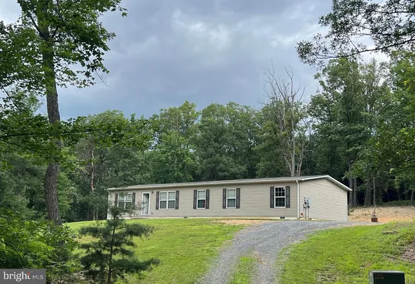 a house with trees in the background