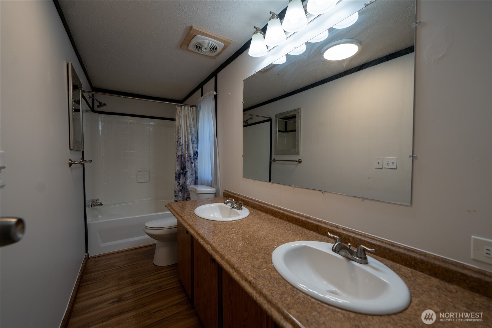 693 John Jacobs Road Port Angeles, WA 98362 - Photo 13 of 30 a bathroom with a granite countertop sink a mirror and a toilet