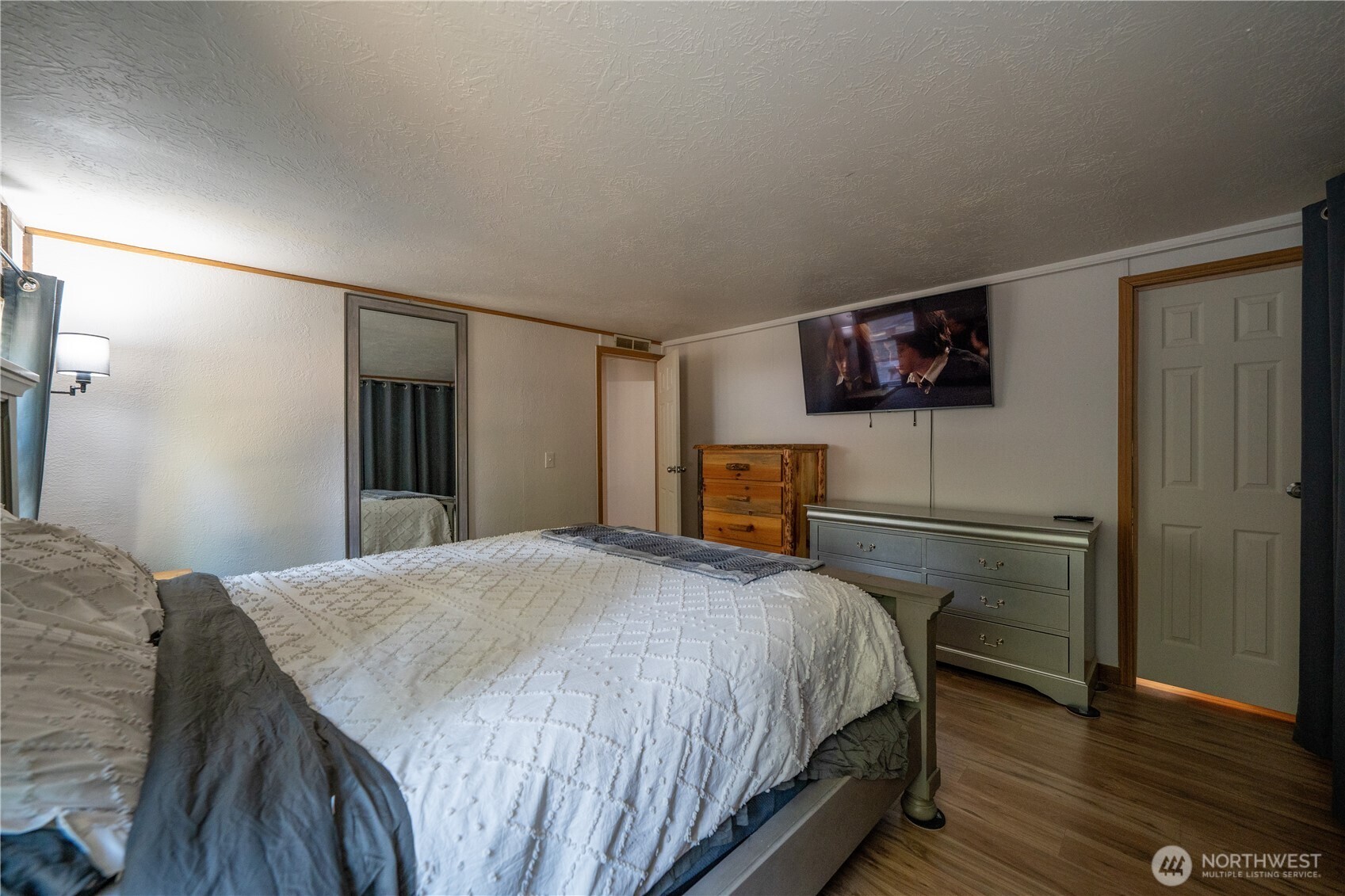 693 John Jacobs Road Port Angeles, WA 98362 - Photo 14 of 30 a bedroom with a bed and a flat screen tv
