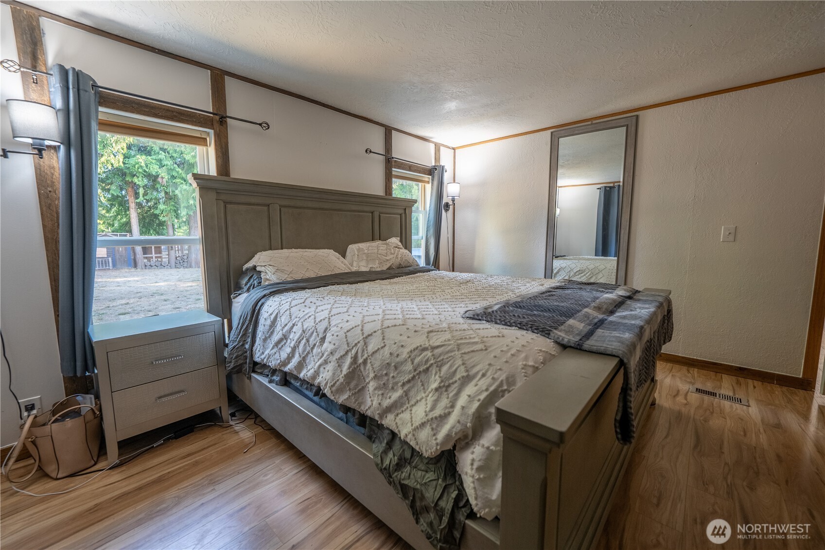 693 John Jacobs Road Port Angeles, WA 98362 - Photo 15 of 30 a bedroom with a bed and wooden floor
