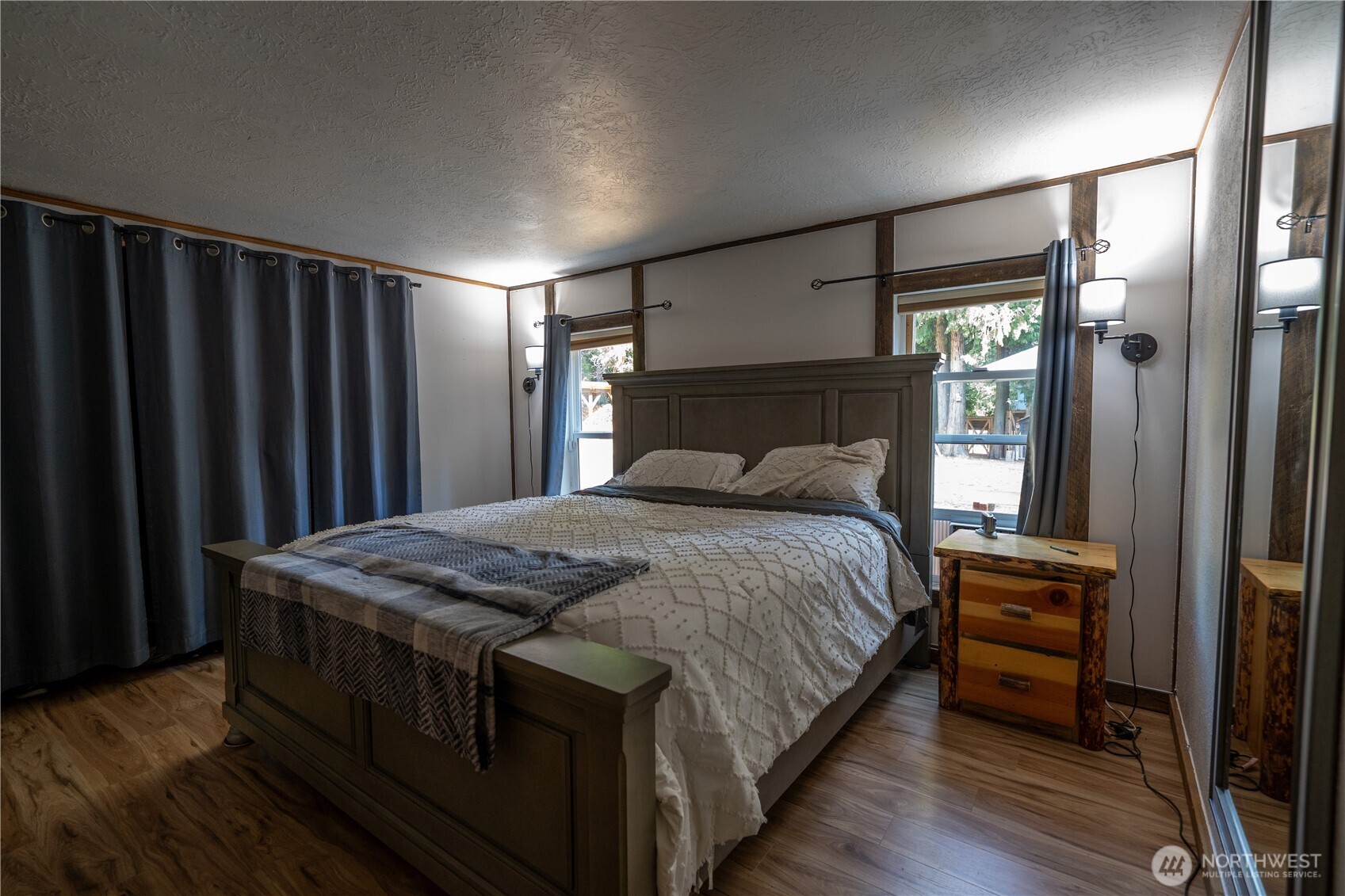 693 John Jacobs Road Port Angeles, WA 98362 - Photo 16 of 30 a bedroom with a bed a dresser and window