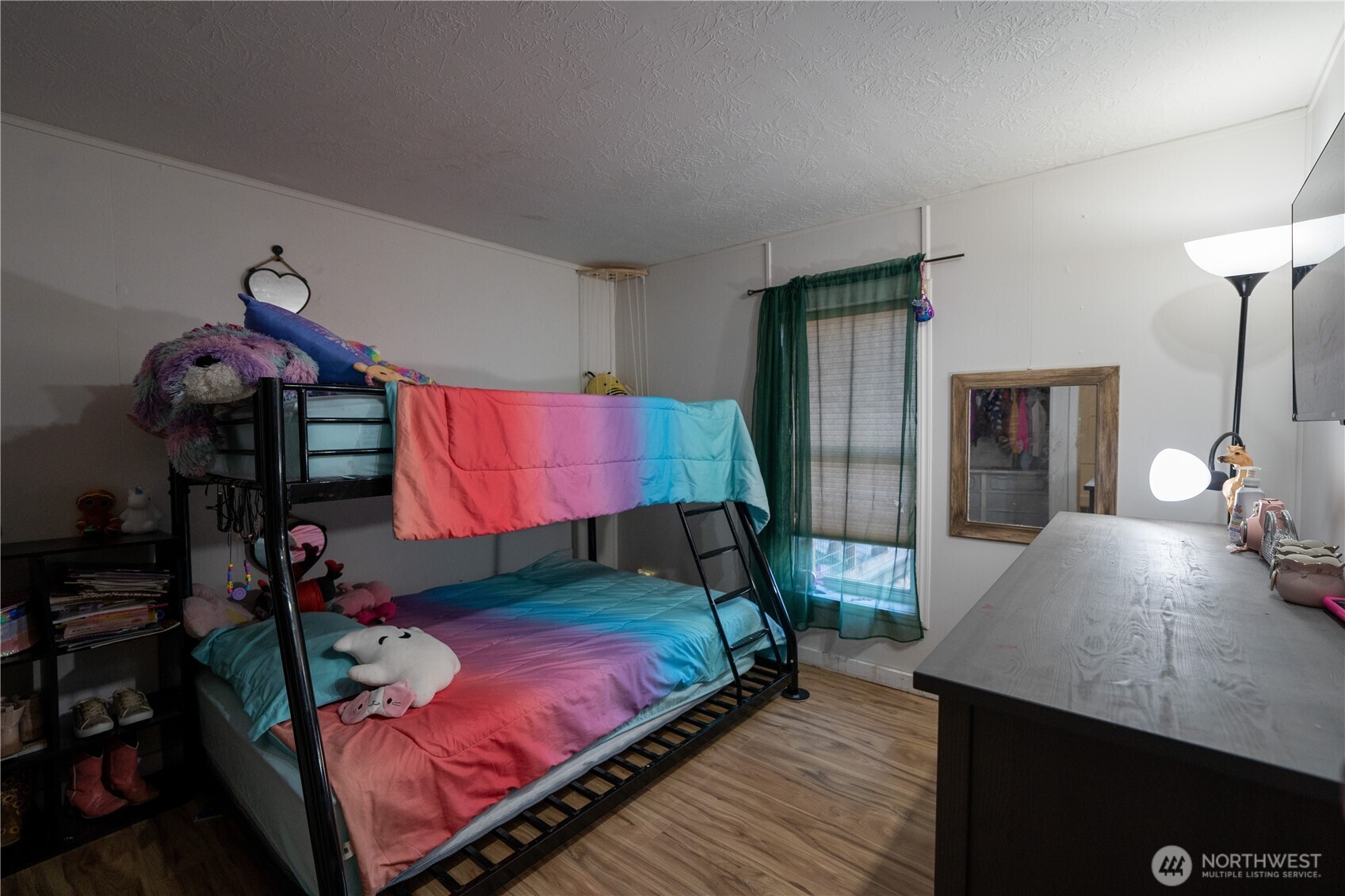 693 John Jacobs Road Port Angeles, WA 98362 - Photo 19 of 30 a bedroom with a bed table and a lamp