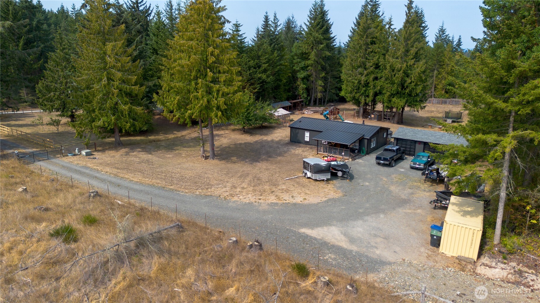 693 John Jacobs Road Port Angeles, WA 98362 - Photo 24 of 30 a view of a backyard with a fire pit and a large tree