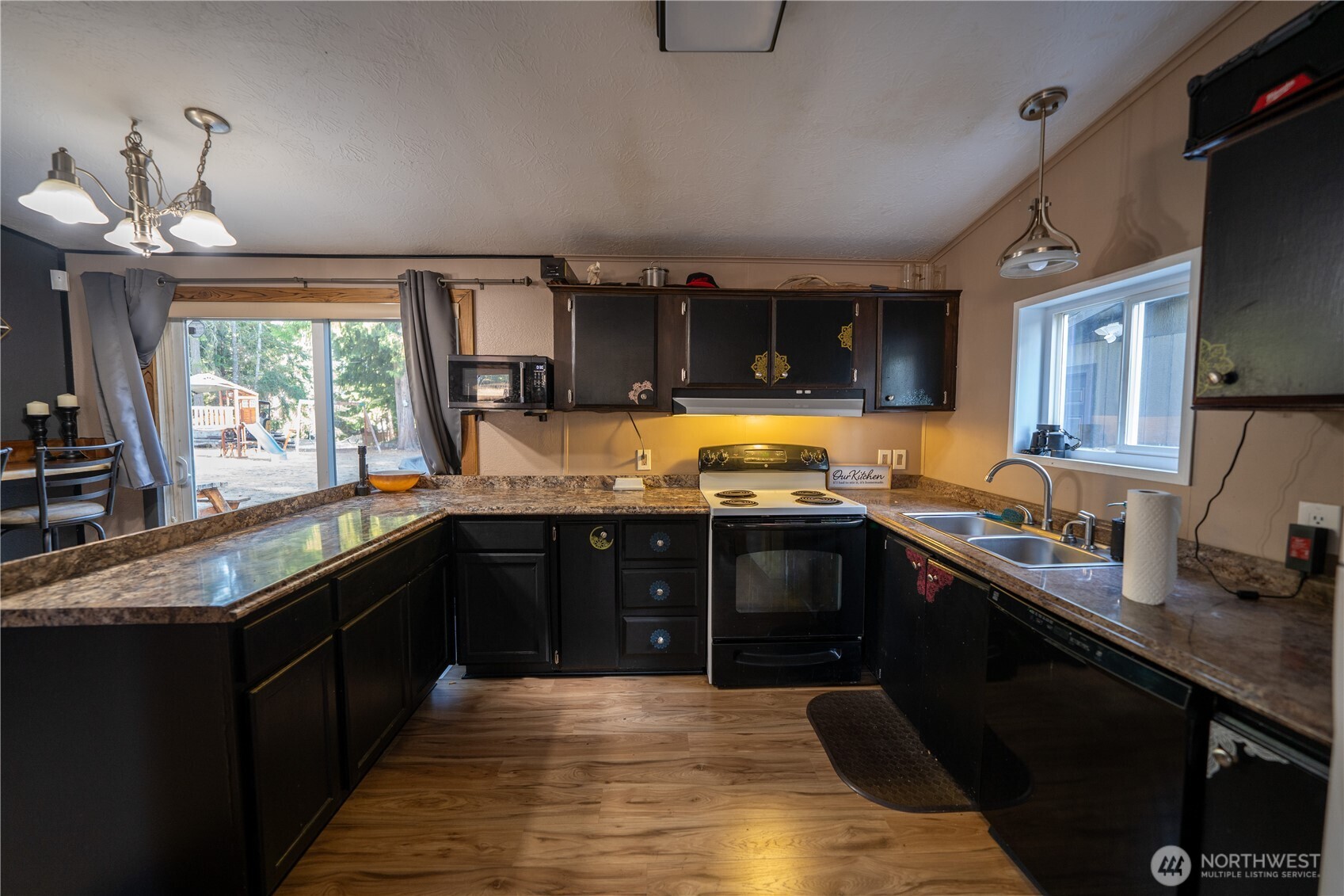 693 John Jacobs Road Port Angeles, WA 98362 - Photo 7 of 30 a kitchen with granite countertop a sink stove and cabinets