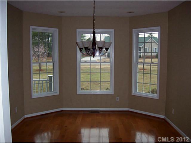 790 Mason Dickson Road York, SC 29745 - Photo 12 of 13 an empty room with wooden floor and windows