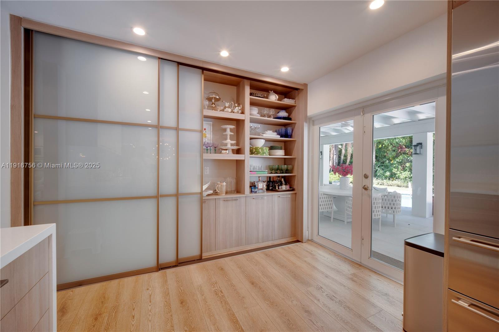 11905 Southwest 67th Avenue Pinecrest, FL 33156 - Photo 14 of 33 a view of kitchen with refrigerator and wooden floor