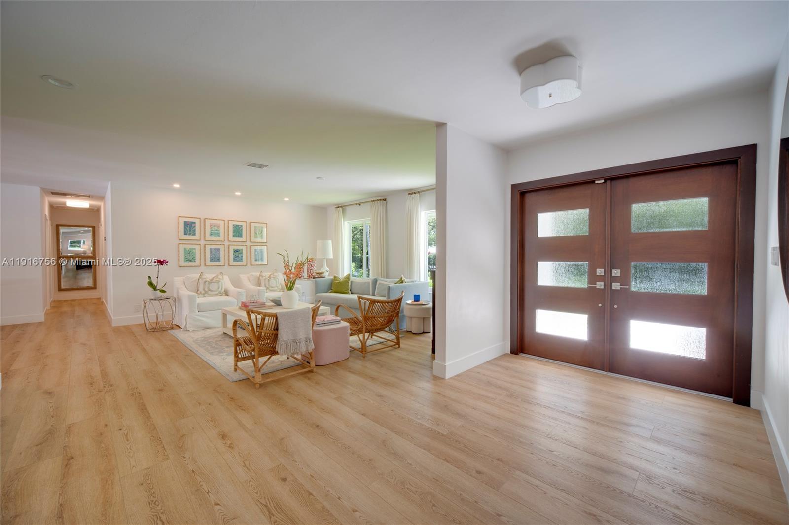 11905 Southwest 67th Avenue Pinecrest, FL 33156 - Photo 15 of 33 a living room with furniture and a wooden floor