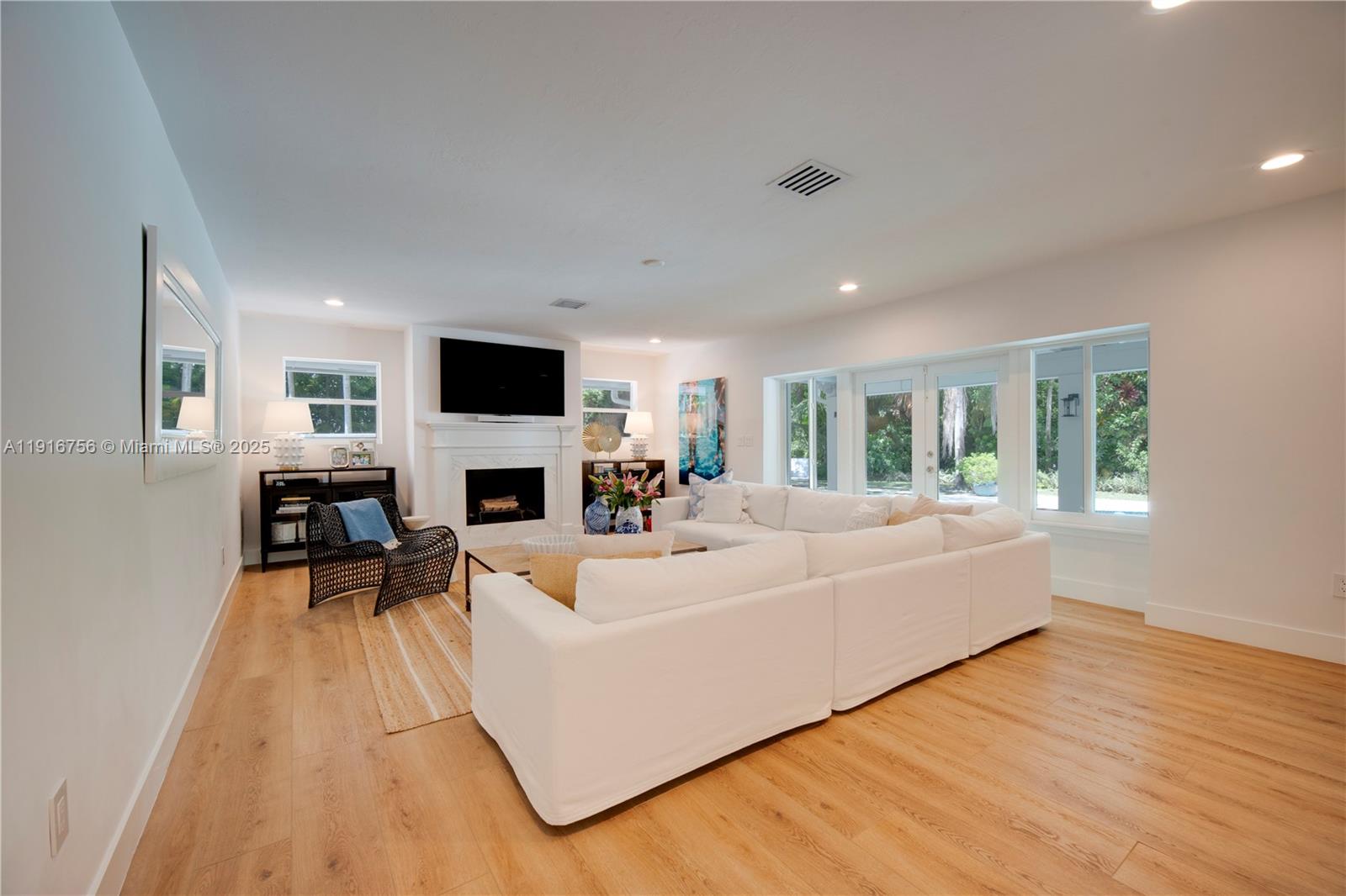 11905 Southwest 67th Avenue Pinecrest, FL 33156 - Photo 17 of 33 a living room with furniture and a fireplace