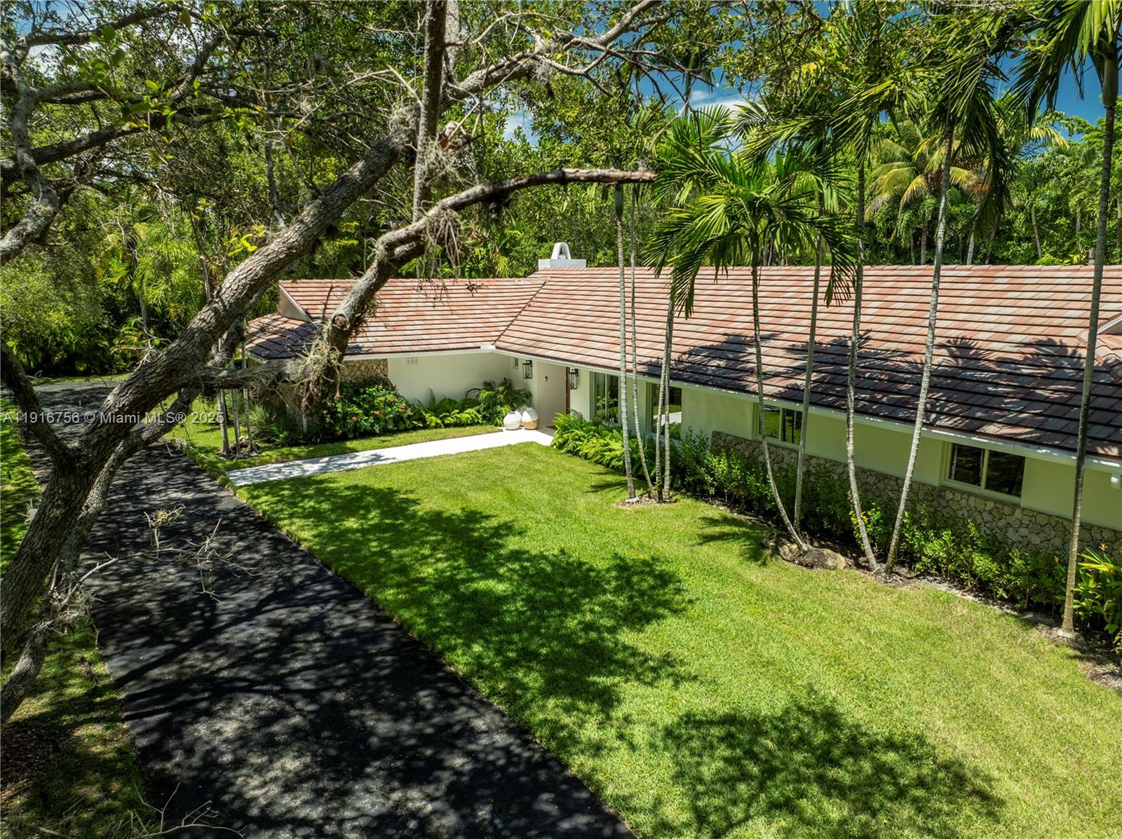 11905 Southwest 67th Avenue Pinecrest, FL 33156 - Photo 2 of 33 a view of a garden with a tree