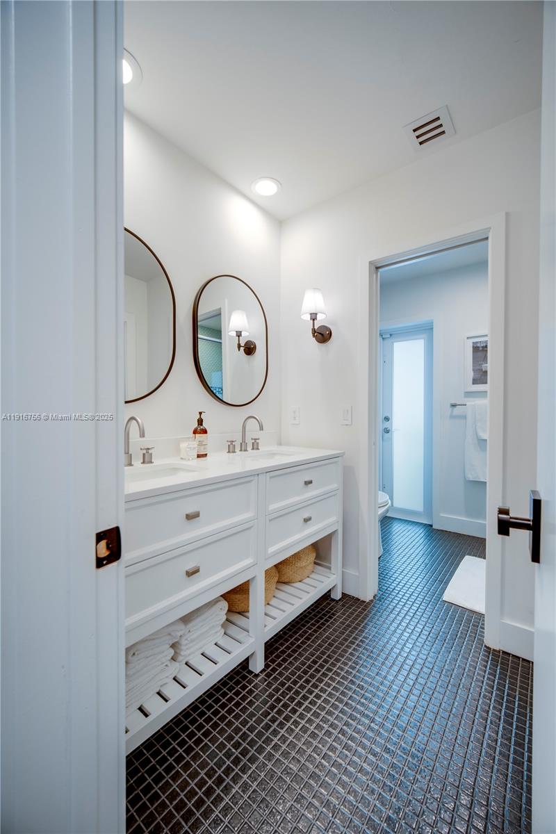 11905 Southwest 67th Avenue Pinecrest, FL 33156 - Photo 21 of 33 a living room with a mirror and a table