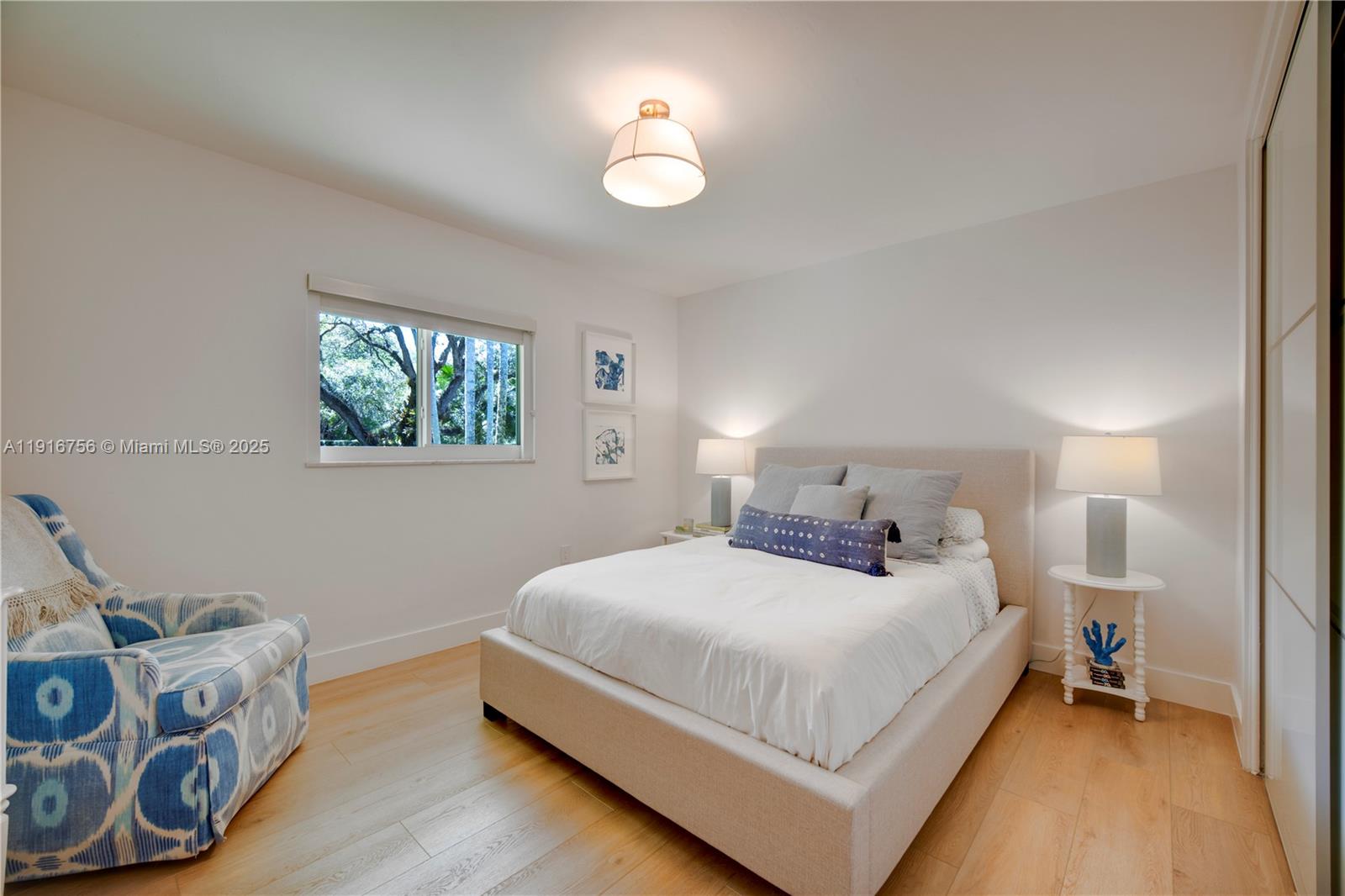 11905 Southwest 67th Avenue Pinecrest, FL 33156 - Photo 23 of 33 a bedroom with a bed and a window