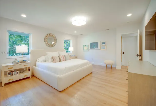 a spacious bedroom with a bed and a large window