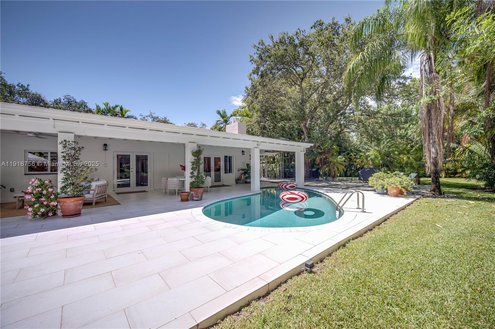 11905 Southwest 67th Avenue Pinecrest, FL 33156 - Photo 5 of 33 a view of a house with backyard and sitting area