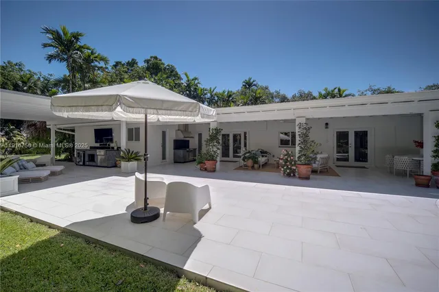 a front view of the house with yard and outdoor seating