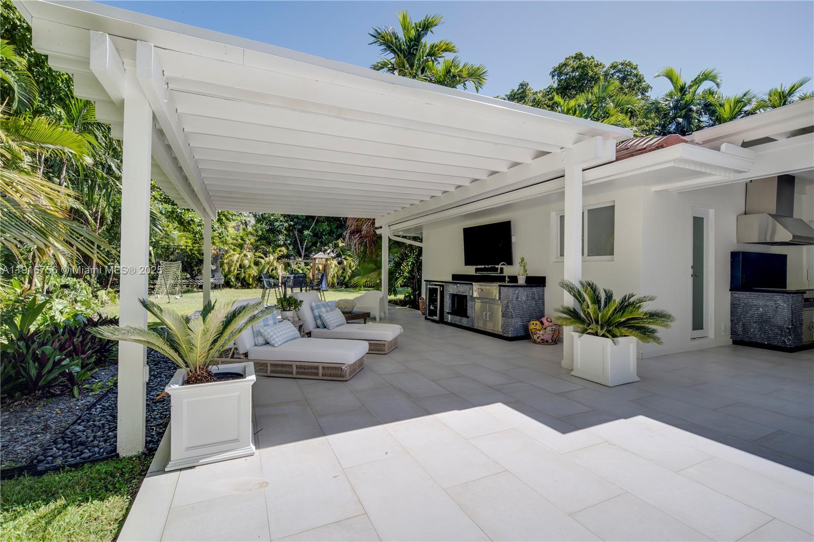 11905 Southwest 67th Avenue Pinecrest, FL 33156 - Photo 7 of 33 a view of a patio with couches and a potted plant