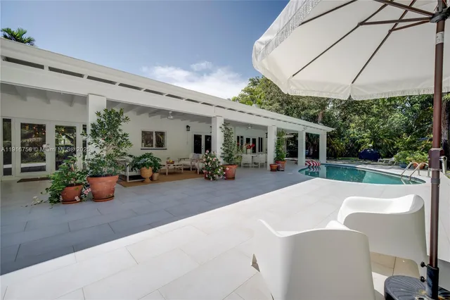 a view of a house with backyard porch and sitting area
