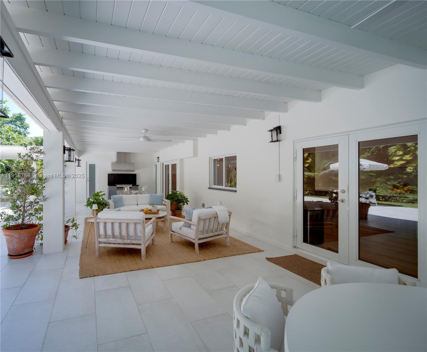 11905 Southwest 67th Avenue Pinecrest, FL 33156 - Photo 10 of 33 a living room with furniture a flat screen tv and a fireplace