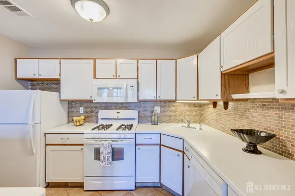 a kitchen with a sink stove and refrigerator