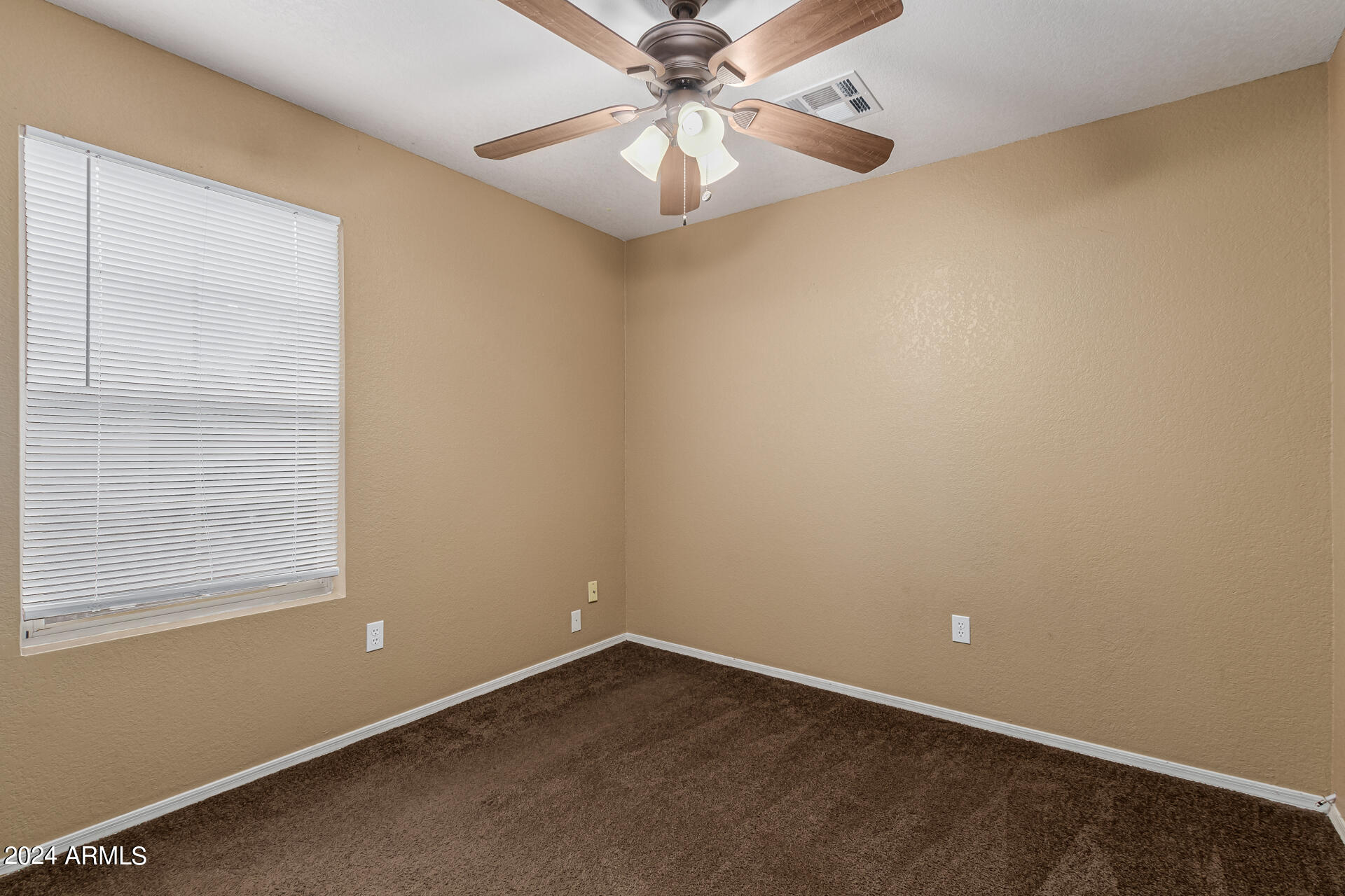 1371 South Boulder Street, Unit A Gilbert, AZ 85296 - Photo 27 of 43 an empty room with a window and a fan
