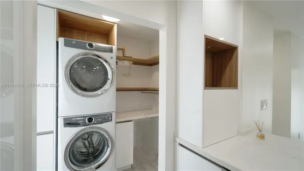 an empty room with wooden floor and closet