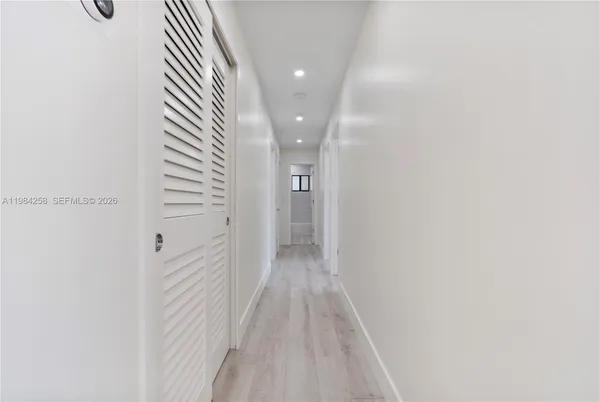 an empty room with windows and closet