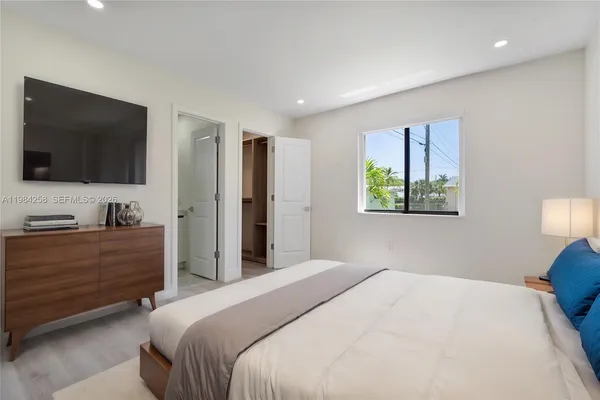 an empty room with wooden floor and closet