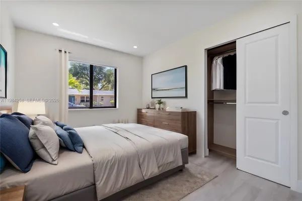a view of house with a big yard and potted plants
