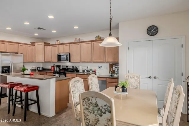 a kitchen with stainless steel appliances granite countertop white cabinets a stove top oven and sink