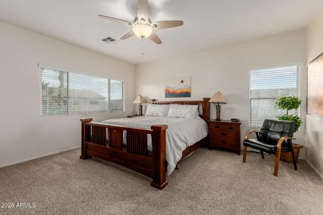 a bedroom with a bed and a book shelf