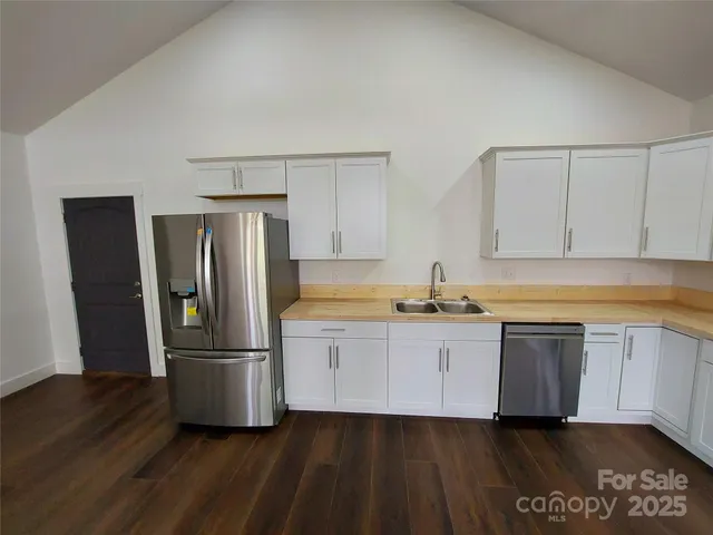 a kitchen with a refrigerator and a sink