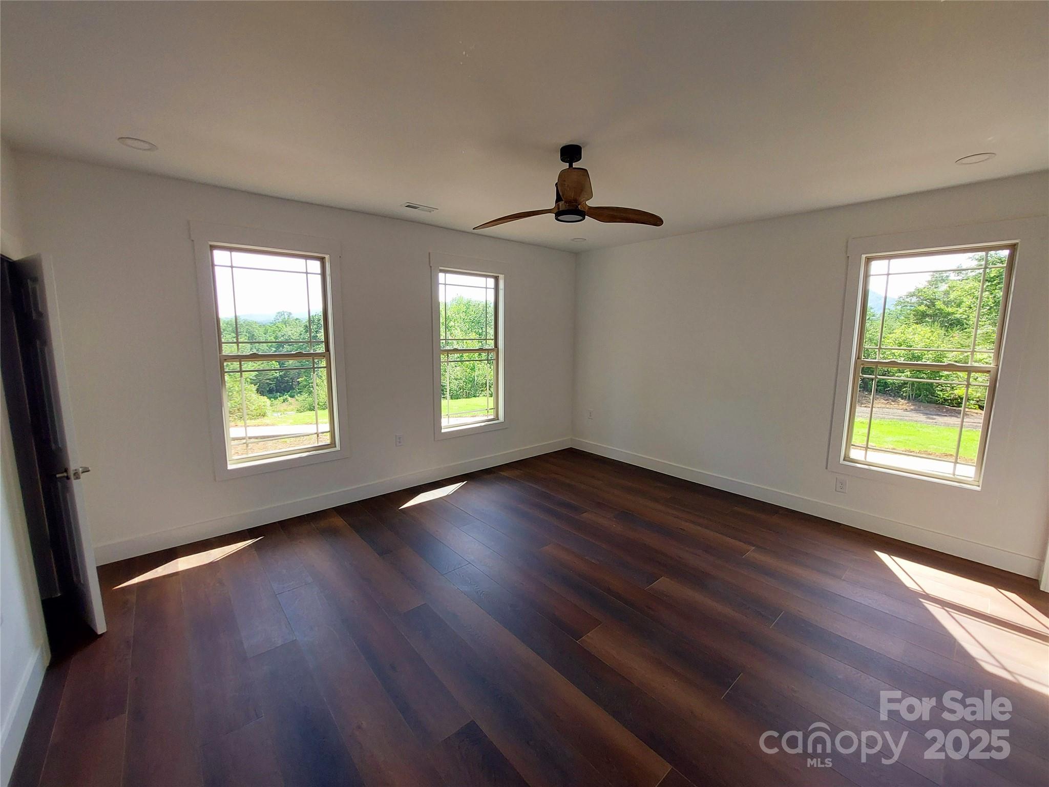401 Constant Lane Columbus, NC 28722 - Photo 17 of 24 a view of an empty room with wooden floor and a window