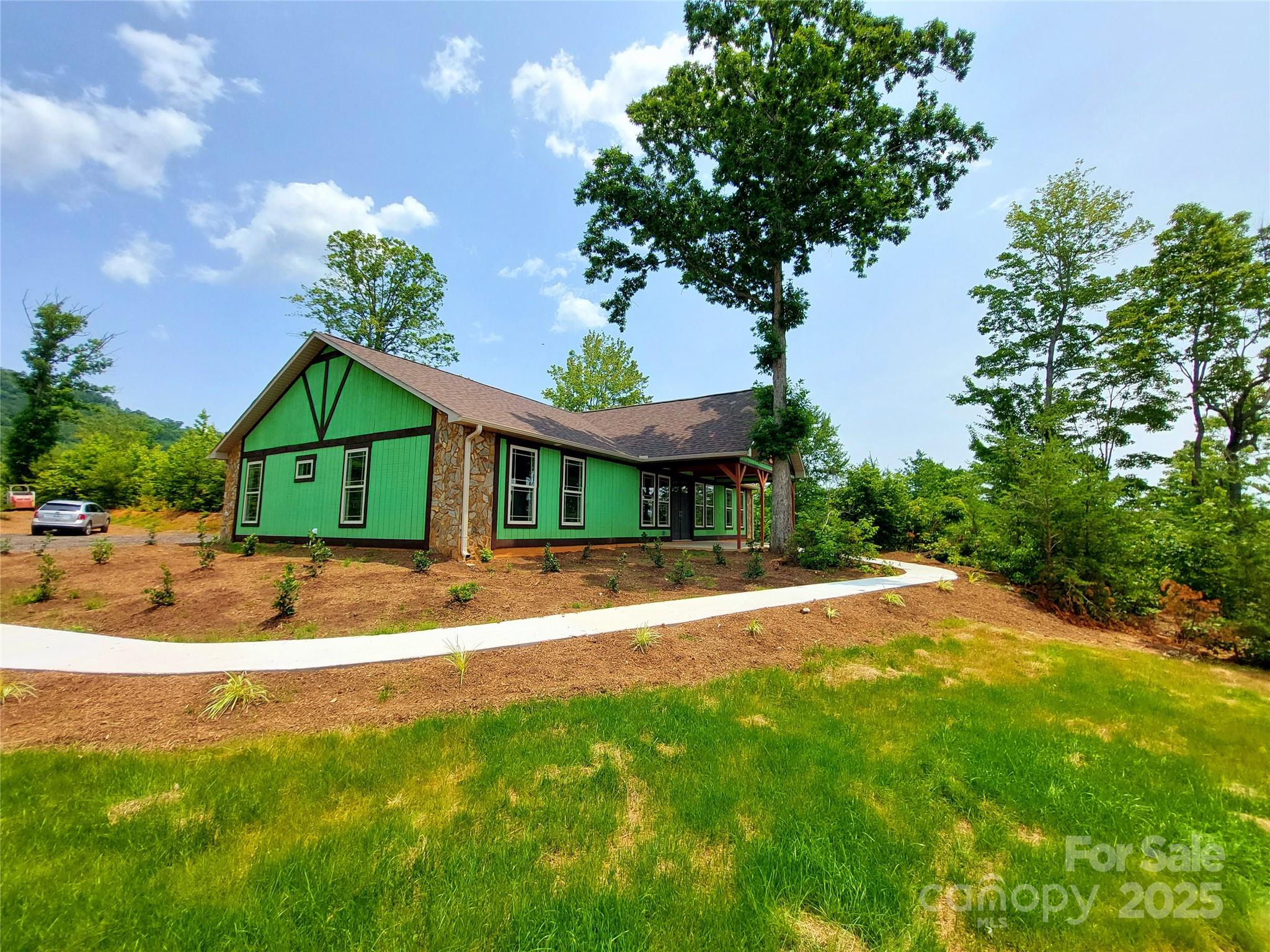 401 Constant Lane Columbus, NC 28722 - Photo 2 of 24 a view of a house with a big yard plants and large tree